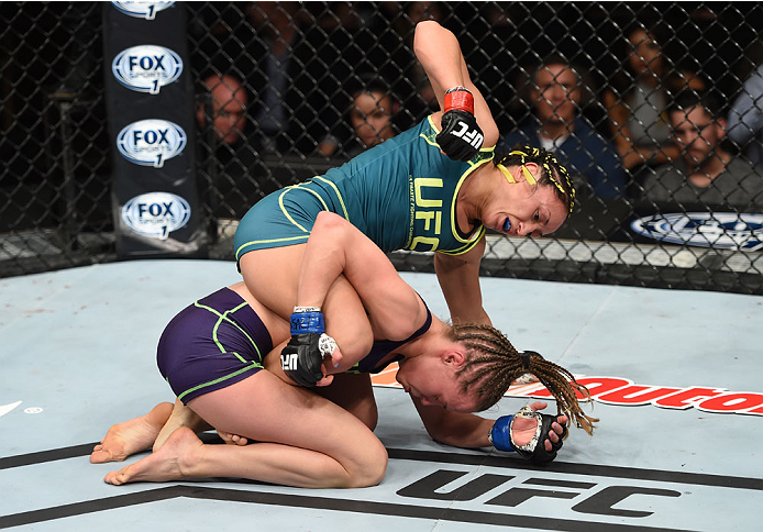 LAS VEGAS, NEVADA - DECEMBER 12: Carla Esparza (top) punches Rose Namajunas in their strawweight championship fight during The Ultimate Fighter Finale event inside the Pearl concert theater at the Palms Casino Resort on December 12, 2014 in Las Vegas, Ne