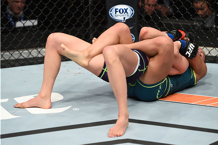 LAS VEGAS, NEVADA - DECEMBER 12: Carla Esparza attempts to submit Rose Namajunas in their strawweight championship fight during The Ultimate Fighter Finale event inside the Pearl concert theater at the Palms Casino Resort on December 12, 2014 in Las Vega