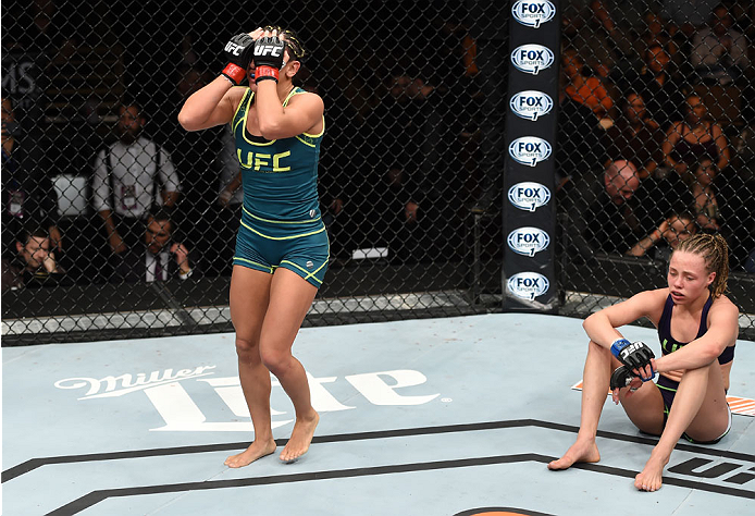 LAS VEGAS, NEVADA - DECEMBER 12: (L-R) Carla Esparza reacts after submitting Rose Namajunas in their strawweight championship fight during The Ultimate Fighter Finale event inside the Pearl concert theater at the Palms Casino Resort on December 12, 2014