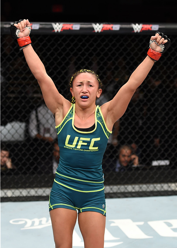 LAS VEGAS, NEVADA - DECEMBER 12: Carla Esparza reacts after submitting Rose Namajunas in their strawweight championship fight during The Ultimate Fighter Finale event inside the Pearl concert theater at the Palms Casino Resort on December 12, 2014 in Las