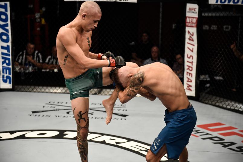 LAS VEGAS, NV - AUGUST 15: (L-R) Martin Day knees Jaime Alvarez in their flyweight bout during Dana White's Tuesday Night Contender Series at the TUF Gym on August 15, 2017 in Las Vegas, Nevada. (Photo by Brandon Magnus/DWTNCS)