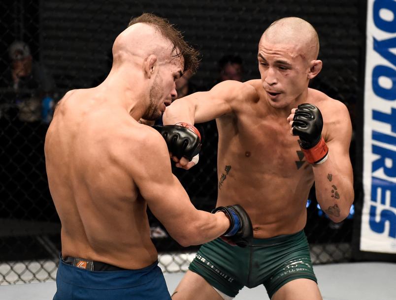 LAS VEGAS, NV - AUGUST 15: (R-L) Martin Day punches Jaime Alvarez in their flyweight bout during Dana White's Tuesday Night Contender Series at the TUF Gym on August 15, 2017 in Las Vegas, Nevada. (Photo by Brandon Magnus/DWTNCS)