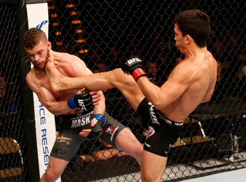 AUSTIN, TX - NOVEMBER 22: (R-L) Joseph Benavidez kicks Dustin Ortiz in their flyweight bout during the UFC Fight Night event at The Frank Erwin Center on November 22, 2014 in Austin, Texas. (Photo by Josh Hedges/Zuffa LLC/Zuffa LLC via Getty Images)