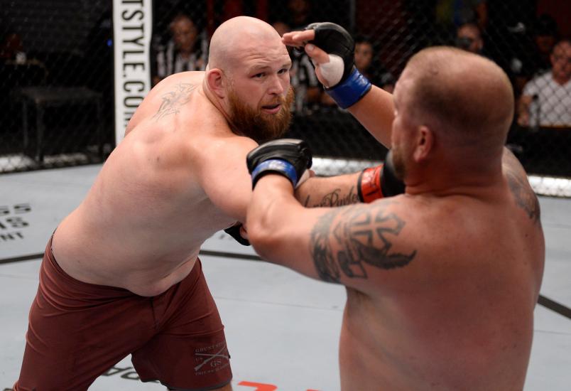 LAS VEGAS, NV - JULY 24: (L-R) Jeff Hughes punches Josh Appelt in their heavyweight fight during Dana White's Tuesday Night Contender Series at the TUF Gym on July 24, 2018 in Las Vegas, Nevada. (Photo by Chris Unger/DWTNCS LLC)