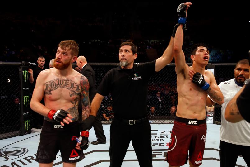 BUENOS AIRES, ARGENTINA - NOVEMBER 17: (R-L) Jesus Pinedo of Peru celebrates after defeating Devin Powell in their lightweight bout during the UFC Fight Night event inside Arena Parque Roca on November 17, 2018 in Buenos Aires, Argentina. (Photo by Alexandre Schneider/Zuffa LLC/Zuffa LLC via Getty Images)