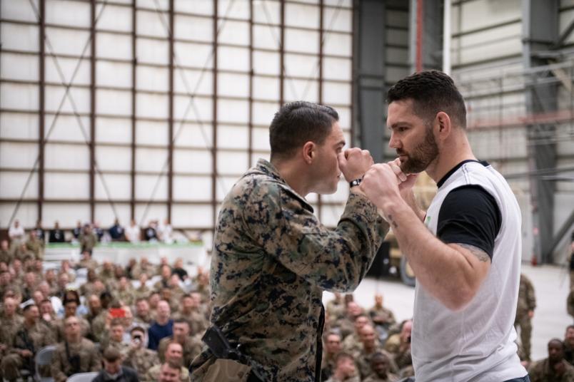 Chris Weidman faces off with a member of the United States military during a portion of his USO Tour visit overseas (DoD Photo by U.S. Army Sgt. James K. McCann).