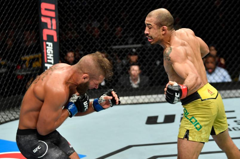 CALGARY, AB - JULY 28: (R-L) Jose Aldo of Brazil drops Jeremy Stephens with a punch to the body in their featherweight bout during the UFC Fight Night event at Scotiabank Saddledome on July 28, 2018 in Calgary, Alberta, Canada. (Photo by Jeff Bottari/Zuffa LLC/Zuffa LLC via Getty Images)