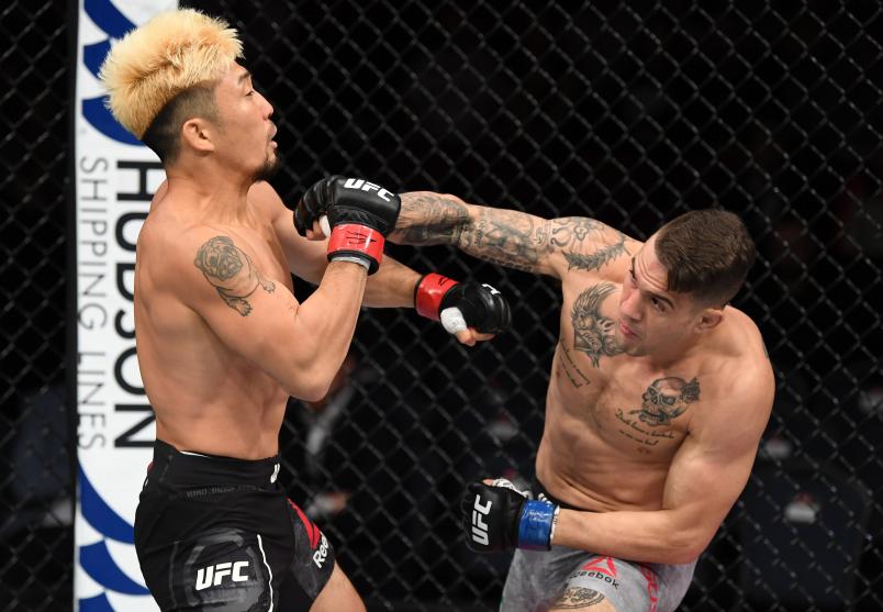 ADELAIDE, AUSTRALIA - DECEMBER 02: (R-L) Christos Giagos punches Mizuto Hirota of Japan in their lightweight bout during the UFC Fight Night event inside Adelaide Entertainment Centre on December 2, 2018 in Adelaide, Australia. (Photo by Jeff Bottari/Zuffa LLC/Zuffa LLC via Getty Images)