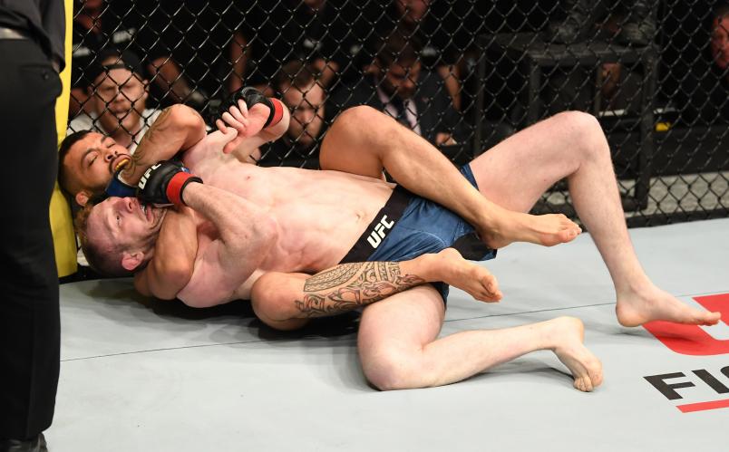 LONDON, ENGLAND - MARCH 16: (L-R) Dan Ige secures a rear choke submission against Danny Henry of Scotland in their featherweight bout during the UFC Fight Night event at The O2 Arena on March 16, 2019 in London, England. (Photo by Jeff Bottari/Zuffa LLC/Zuffa LLC via Getty Images)