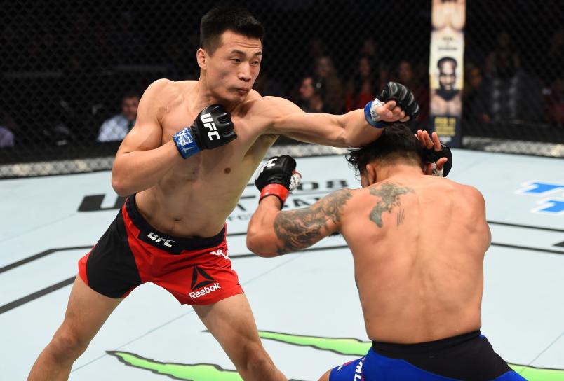 HOUSTON, TX - FEBRUARY 04: (L-R) Chan Sung Jung of South Korea punches Dennis Bermudez in their featherweight bout during the UFC Fight Night event at the Toyota Center on February 4, 2017 in Houston, Texas. (Photo by Jeff Bottari/Zuffa LLC/Zuffa LLC via Getty Images)