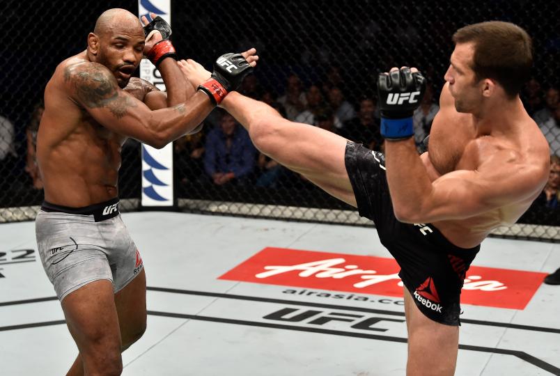 PERTH, AUSTRALIA - FEBRUARY 11: (R-L) Luke Rockhold kicks Yoel Romero of Cuba in their interim middleweight title bout during the UFC 221 event at Perth Arena on February 11, 2018 in Perth, Australia. (Photo by Jeff Bottari/Zuffa LLC/Zuffa LLC via Getty Images)