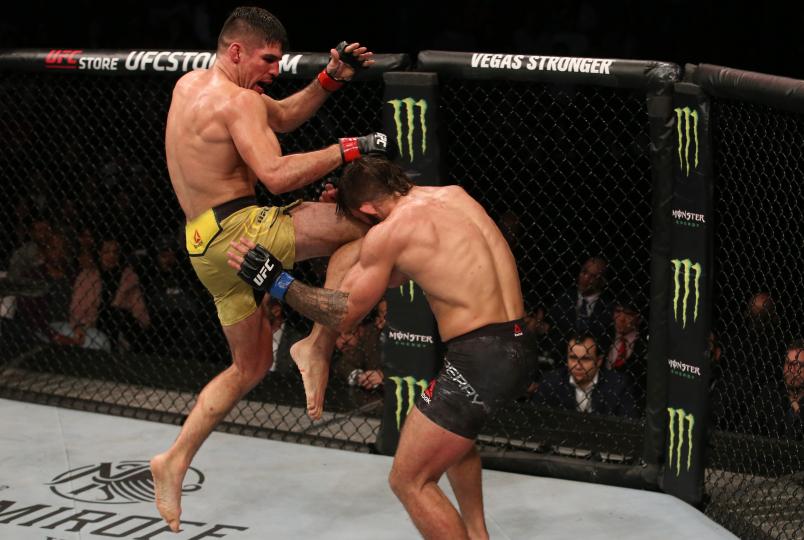 MONTEVIDEO, URUGUAY - AUGUST 10: (L-R) Vicente Luque lands a flying knee against Mike Perry in their welterweight fight during the UFC Fight Night event at Antel Arena on August 10, 2019 in Montevideo, Uruguay. (Photo by Alexandre Schneider /Zuffa LLC