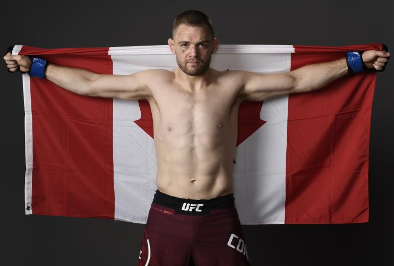 Tristan Connelly poses with Canadian flag, 2019
