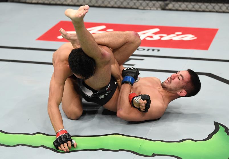 BEIJING, CHINA - NOVEMBER 24: (R-L) Louis Smolka attempts to secure a submission against Su Mudaerji of China in their bantamweight bout during the UFC Fight Night event inside Cadillac Arena on November 24, 2018 in Beijing, China. (Photo by Jeff Bottari/Zuffa LLC)