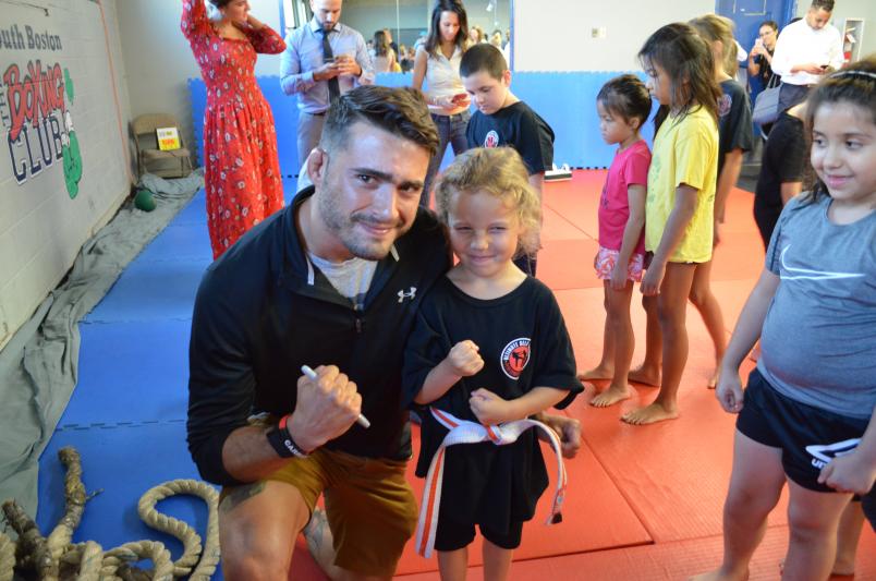 UFC Fighter Randy Costa poses with a young fan