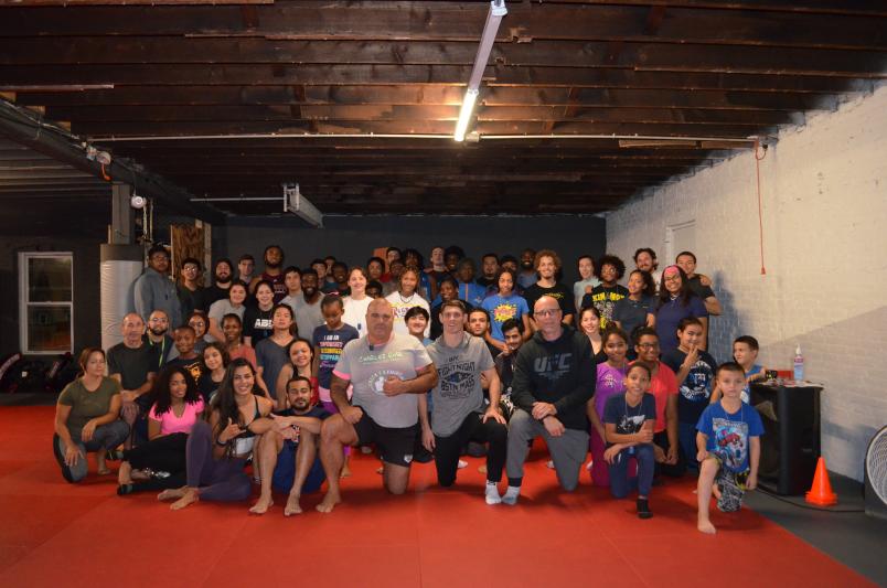 UFC Fighter Charles Rosa poses with students at Level Ground MMA