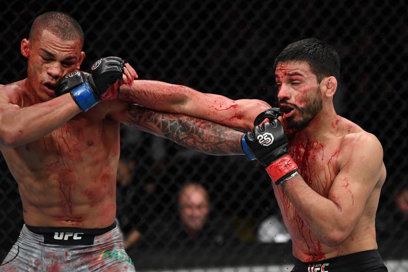 NEW YORK, NY - NOVEMBER 03: (R-L) Julio Arce and Sheymon Moraes of Brazil exchange punches in their featherweight bout during the UFC 230 event inside Madison Square Garden on November 3, 2018 in New York, New York. (Photo by Jeff Bottari/Zuffa LLC/Zuffa LLC via Getty Images)