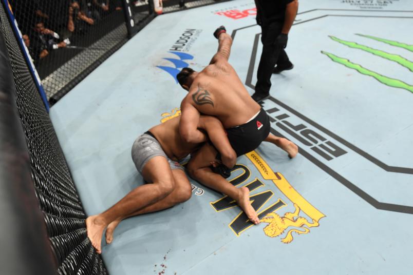 Greg Hardy punches Juan Adams in their heavyweight bout during the UFC Fight Night event at AT&T Center on July 20, 2019 in San Antonio, Texas. (Photo by Josh Hedges/Zuffa LLC/Zuffa LLC via Getty Images)