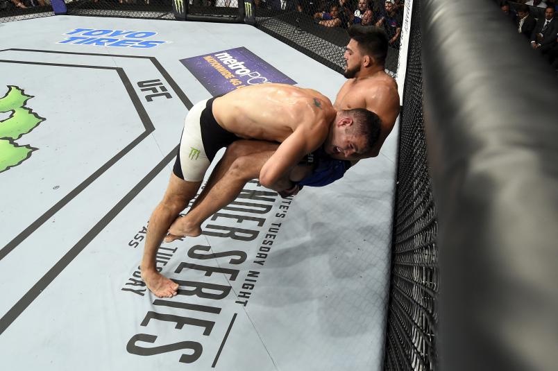 Chris Weidman takes down Kelvin Gastelum in their middleweight bout during the UFC Fight Night event inside the Nassau Veterans Memorial Coliseum on July 22, 2017 in Uniondale, New York. (Photo by Josh Hedges/Zuffa LLC/Zuffa LLC via Getty Images)