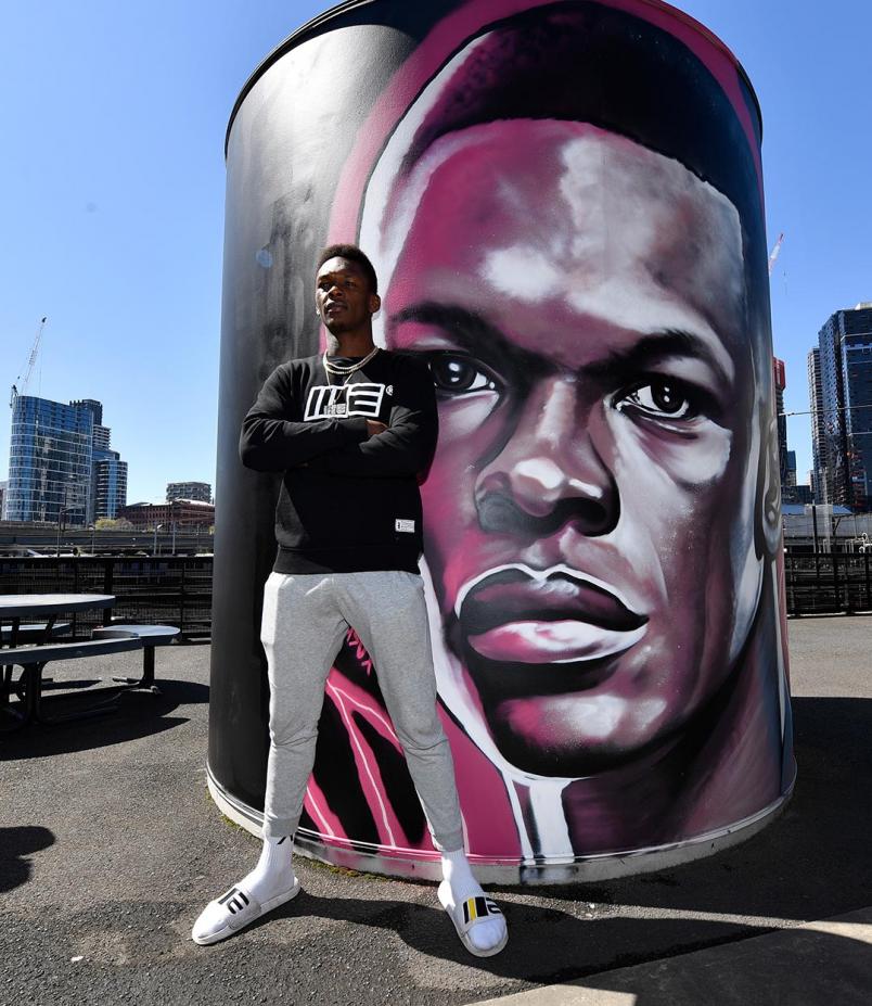 Israel Adesanya Poses Next To His Marvel Stadium Mural (Photo by Jeff Bottari/Zuffa LLC)
