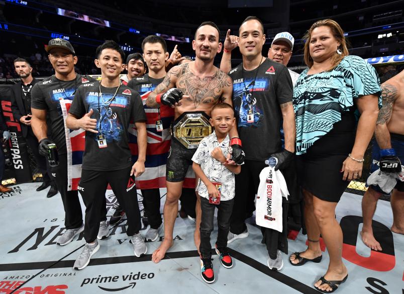 EDMONTON, ALBERTA - JULY 27: Max Holloway poses for a photo with his family and teammates after defeating Frankie Edgar in their UFC featherweight championship bout during the UFC 240 event at Rogers Place on July 27, 2019 in Edmonton, Alberta, Canada. (Photo by Jeff Bottari/Zuffa LLC/Zuffa LLC)