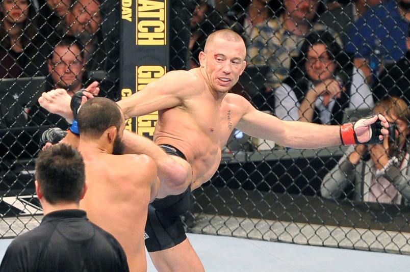 LAS VEGAS, NEVADA - NOVEMBER 16: Georges St-Pierre (R) kicks Johny Hendricks in their UFC welterweight championship bout during the UFC 167 event at the MGM Grand Garden Arena on November 16, 2013 in Las Vegas, Nevada. (Photo by Jeff Bottari/Zuffa LLC/Zuffa LLC via Getty Images)