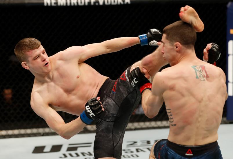 ROCHESTER, NY - MAY 18: (L-R) Grant Dawson kicks Michael Trizano in their featherweight bout during the UFC Fight Night event at Blue Cross Arena on May 18, 2019 in Rochester, New York. (Photo by Michael Owens/Zuffa LLC/Zuffa LLC via Getty Images)