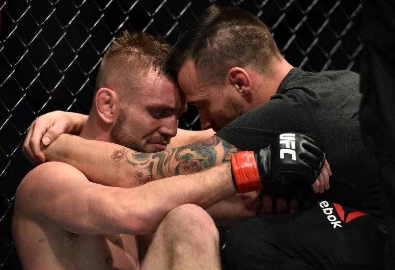 LAS VEGAS, NV - DECEMBER 30: (L-R) An emotional Tim Elliott talks with teammate James Krause in the Octagon after his victory over Mark De La Rosa during the UFC 219 event inside T-Mobile Arena on December 30, 2017 in Las Vegas, Nevada. Elliott's head coach Robert Follis passed away unexpectedly on December 15. (Photo by Brandon Magnus/Zuffa LLC/Zuffa LLC via Getty Images)
