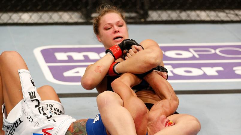 ANAHEIM, CA - FEBRUARY 23: Ronda Rousey (black shorts) secures an arm bar submission against Liz Carmouche in their women's bantamweight title fight during UFC 157 at Honda Center on February 23, 2013 in Anaheim, California. (Photo by Josh Hedges/Zuffa