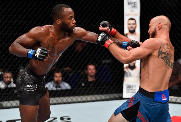 SINGAPORE - JUNE 23: (L-R) Leon Edwards of Jamaica punches Donald Cerrone in their welterweight bout during the UFC Fight Night event at the Singapore Indoor Stadium on June 23, 2018 in Singapore. (Photo by Jeff Bottari/Zuffa LLC/Zuffa LLC via Getty Imag