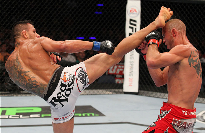 INDIANAPOLIS, IN - AUGUST 28: (L-R) Rafael dos Anjos punches Donald "Cowboy" Cerrone in their lightweight fight during the UFC on FOX Sports 1 event at Bankers Life Fieldhouse on August 28, 2013 in Indianapolis, Indiana. (Photo by Ed Mulholland/Zuffa LLC