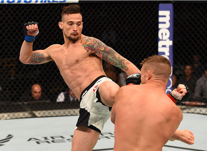 CHICAGO, IL - JULY 25: (L-R) James Krause kicks Daron Cruickshank in their lightweight bout during the UFC event at the United Center on July 25, 2015 in Chicago, Illinois. (Photo by Jeff Bottari/Zuffa LLC/Zuffa LLC via Getty Images)