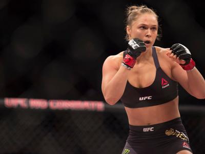 RIO DE JANEIRO, BRAZIL - AUGUST 01:  UFC women's bantamweight champion Ronda Rousey of the United States rushes forward against Bethe Correia of Brazil during the UFC 190 event inside HSBC Arena on August 1, 2015 in Rio de Janeiro, Brazil.  (Photo by Jeff
