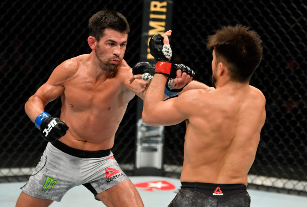 JACKSONVILLE, FLORIDA - MAY 09: (L-R) Dominick Cruz punches Henry Cejudo in their UFC bantamweight championship fight during the UFC 249