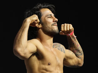 Alexandre Pantoja of Brazil poses on the scale during the UFC 290 ceremonial weigh-in at T-Mobile Arena on July 07, 2023 in Las Vegas, Nevada. 