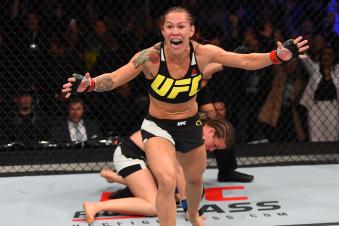 CURITIBA, BRAZIL - MAY 14:  (L-R) Cristiane 'Cyborg' Justino of Brazil celebrates after defeating Leslie Smith in their women's catchweight bout during the UFC 198 event at Arena da Baixada stadium on May 14, 2016 in Curitiba, Parana, Brazil.  (Photo by Josh Hedges/Zuffa LLC via Getty Images)
