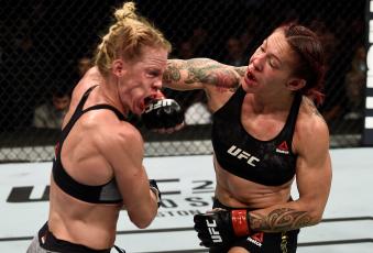 LAS VEGAS, NV - DECEMBER 30:  (R-L) Cris Cyborg of Brazil punches Holly Holm in their women's featherweight bout during the UFC 219 event inside T-Mobile Arena on December 30, 2017 in Las Vegas, Nevada. (Photo by Jeff Bottari/Zuffa LLC via Getty Images)