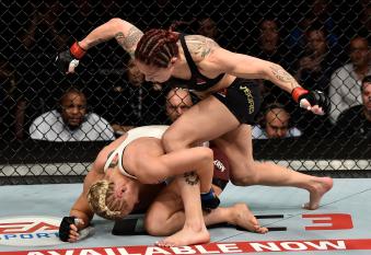 LAS VEGAS, NV - MARCH 03:   (R-L) Cris Cyborg of Brazil punches Yana Kunitskaya of Russia in their women's featherweight bout during the UFC 222 event inside T-Mobile Arena on March 3, 2018 in Las Vegas, Nevada. (Photo by Jeff Bottari/Zuffa LLC via Getty Images)