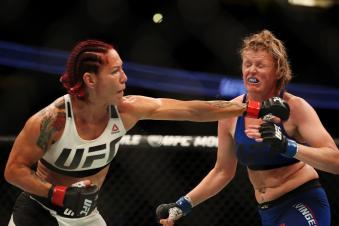 Cris Cyborg punches Tonya Evinger in their UFC women's featherweight championship bout during the UFC 214 event at Honda Center on July 29, 2017 in Anaheim, California.