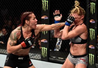 LAS VEGAS, NV - DECEMBER 30:  (L-R) Cris Cyborg of Brazil punches Holly Holm in their women's featherweight bout during the UFC 219 event inside T-Mobile Arena on December 30, 2017 in Las Vegas, Nevada. (Photo by Jeff Bottari/Zuffa LLC via Getty Images)