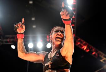 CURITIBA, BRAZIL - MAY 14:  (L-R) Cristiane 'Cyborg' Justino of Brazil celebrates after defeating Leslie Smith in their women's catchweight bout during the UFC 198 event at Arena da Baixada stadium on May 14, 2016 in Curitiba, Parana, Brazil.  (Photo by Josh Hedges/Zuffa LLC via Getty Images)
