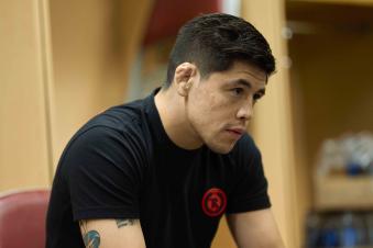 Brandon Moreno watches his teammate Johnny Munoz warm up backstage during the UFC 265 event