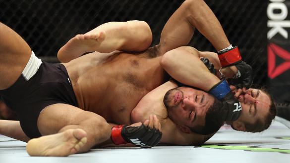BOSTON, MA - JANUARY 17:  Luke Sanders chokes Maximo Blanco in their featherweight bout during UFC Fight Night 81 at TD Banknorth Garden on January 17, 2016 in Boston, Massachusetts.  (Photo by Tim Bradbury/Getty Images)