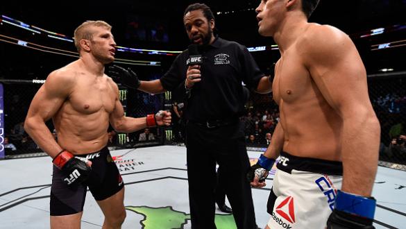 BOSTON, MA - JANUARY 17:  (L-R) Opponents TJ Dillashaw and Dominick Cruz receive final instructions from referee Herb Dean before their UFC bantamweight championship bout during the UFC Fight Night event inside TD Garden on January 17, 2016 in Boston, Mas