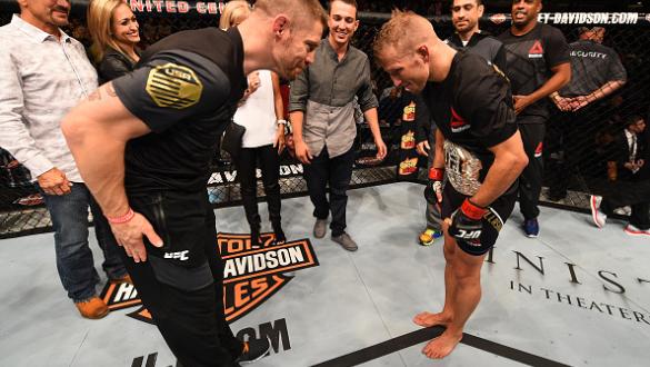 CHICAGO, IL - JULY 25:   TJ Dillashaw (R) is congratulated by coach Duane Ludwig after his TKO victory over Renan Barao of Brazil in their UFC bantamweight championship bout during the UFC event at the United Center on July 25, 2015 in Chicago, Illinois. 
