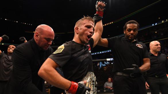 CHICAGO, IL - JULY 25:   TJ Dillashaw celebrates after his TKO victory over Renan Barao of Brazil UFC bantamweight championship bout during the UFC event at the United Center on July 25, 2015 in Chicago, Illinois. (Photo by Jeff Bottari/Zuffa LLC/Zuffa LL