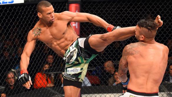 HOLLYWOOD, FL - JUNE 27:   (L-R) Thiago Santos of Brazil lands a kick to the head of Steve Bosse of Canada in their middleweight during the UFC Fight Night event at the Hard Rock Live on June 27, 2015 in Hollywood, Florida. (Photo by Josh Hedges/Zuffa LLC