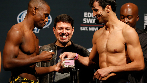AUSTIN, TX - NOVEMBER 21:  (L-R) Opponents Yves Edwards of the Bahamas and Akbarh Arreola of Mexico share a snake after making weight during the UFC weigh-in at The Frank Erwin Center on November 21, 2014 in Austin, Texas.  (Photo by Josh Hedges/Zuffa LLC