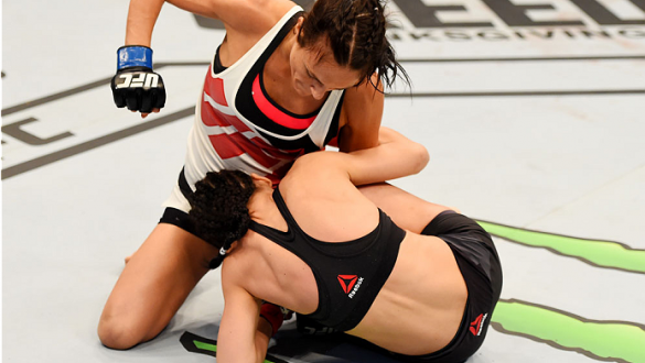 MELBOURNE, AUSTRALIA - NOVEMBER 15: Valerie Letourneau works from the top as she punches Joanna Jedrzejczyk (B) in their UFC women's strawweight championship bout during the UFC 193 event at Etihad Stadium on November 15, 2015 in Melbourne, Australia.  (P