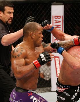 LAS VEGAS, NV - JANUARY 03:  (L-R) Hector Lombard punches Josh Burkman in their welterweight bout during the UFC 182 event on at the MGM Grand Garden Arena January 3, 2015 in Las Vegas, Nevada.  (Photo by Josh Hedges/Zuffa LLC/Zuffa LLC via Getty Images)